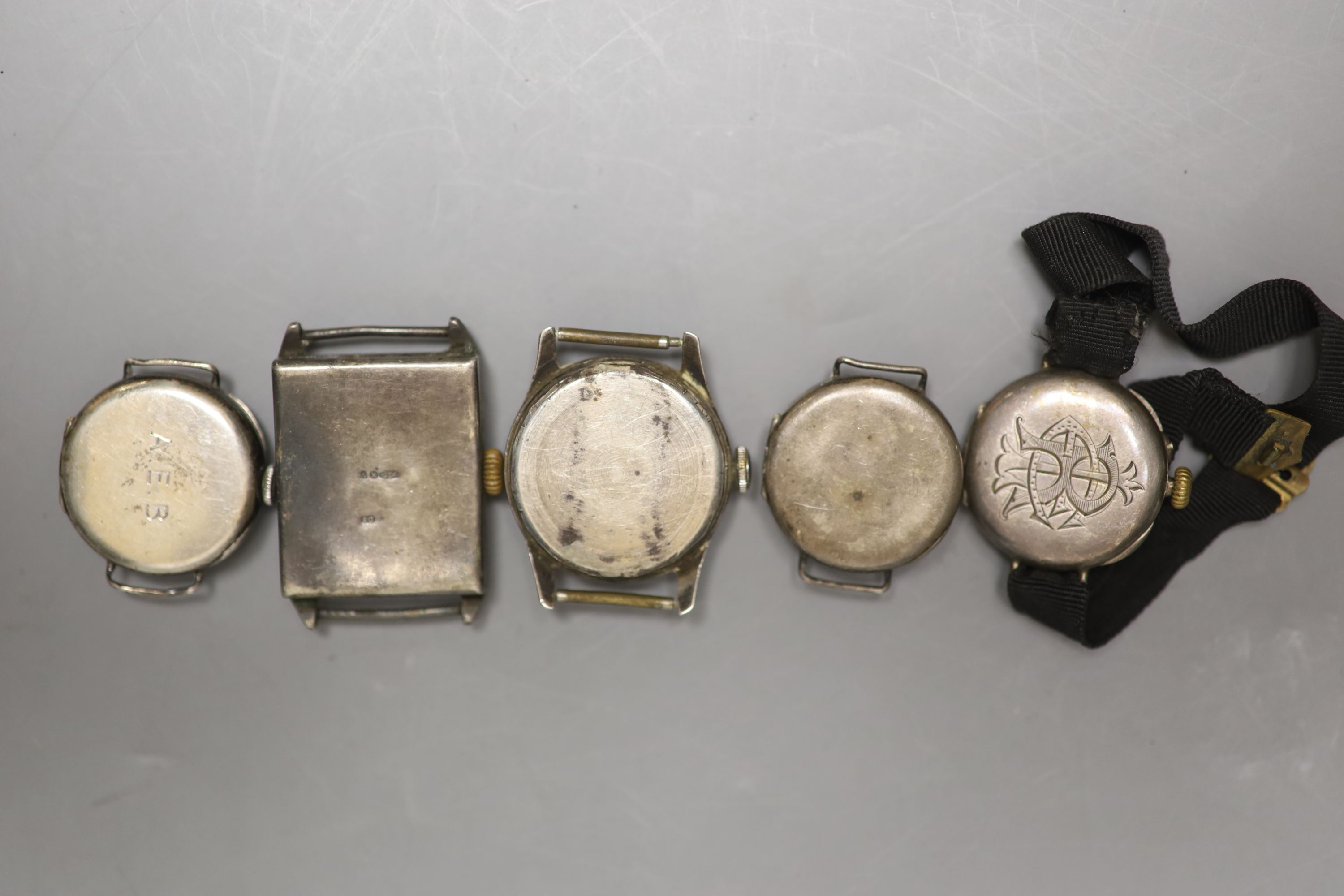 Five assorted wrist watches including four silver(a.f.).